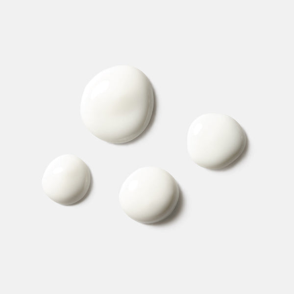 Four white serum droplets on a light background representing the texture of Solar Dew SPF Mineral Serum | HydroPeptide skincare product.