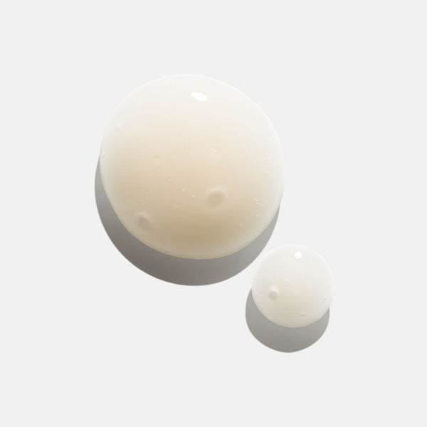 Two translucent droplets of Power Serum | HydroPeptide displayed on a light background, highlighting the serum’s smooth texture and clarity for skincare use.