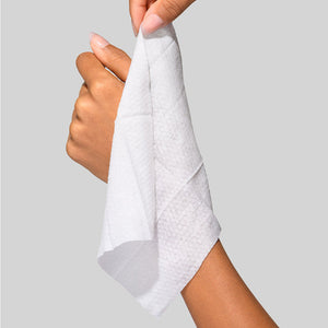 Person holding a soft white cleansing cloth, demonstrating its texture and size, featuring Hydroactive Cleanse Cloths - 30 Pack | HydroPeptide for skincare use.