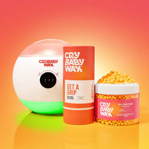 The Meltdown Machine Wax Warmer | Crybaby Wax with accompanying Crybaby Wax body and skin care products displayed against a warm gradient background for wellness and recovery use.