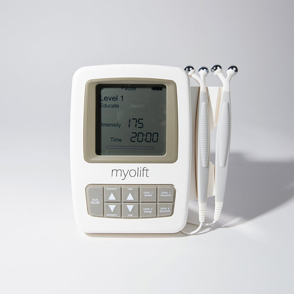 White handheld Mini Spa Starter Microcurrent Facial Kit | 7e Wellness device with three rounded metal probe attachments and a digital screen displaying settings for level, intensity, and time.