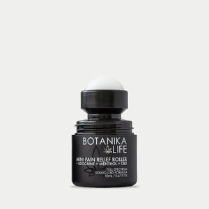 Black roller bottle labeled Botanika Life mini pain relief roller with lid off, showcasing a wellness device included in the Spafinder Travel Kit | Live Love Spa.