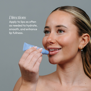 A woman applying Lip Renewing Hydrator - Naked | Circadia to her lips, demonstrating skincare use for hydration and enhancing lip fullness.