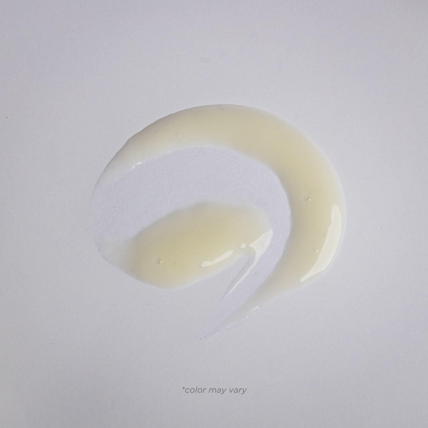 Close-up of a smooth, translucent serum smear on a white surface showcasing the texture of Pigment Perfecting Serum | Alchimie Forever skincare product.