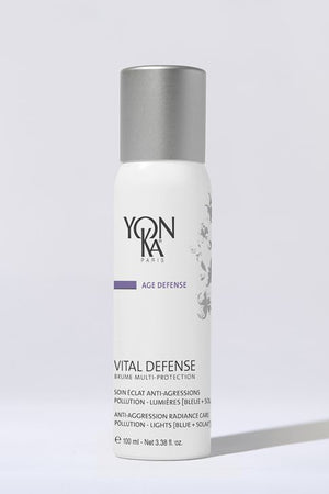 White bottle of Vital Defense Mist | Yon-Ka Paris skincare product with silver cap, designed for anti-aggression radiance care and pollution protection, displayed on light background.