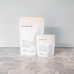 Ancient Oat Hydration Crush 120g/4oz| Bathorium product packages displayed on a tiled surface with Bathorium branding and Ancient Oat Hydration text visible