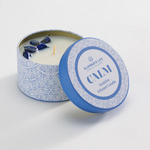 Calm Candle Tin 6 oz | Aluminate Life features a blue patterned tin with sodalite crystals embedded in a white candle, designed for wellness and relaxation.
