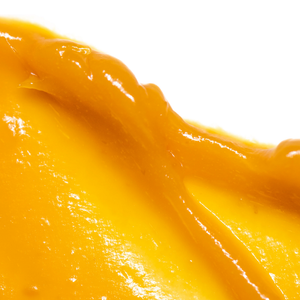Close-up of smooth, vibrant orange cream texture representing Cell-Tex Vitamin C Cream | Skin Fitness Therapy, a skincare product promoting skin wellness and vitality.