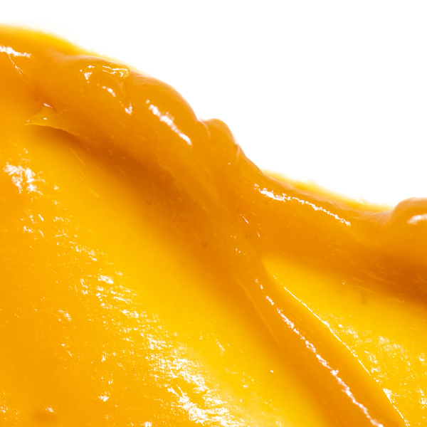 Close-up of smooth, vibrant orange cream texture representing Cell-Tex Vitamin C Cream | Skin Fitness Therapy, a skincare product promoting skin wellness and vitality.