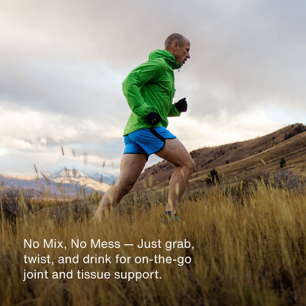 Active man in green jacket running outdoors on a trail in a grassy landscape, promoting Collagen Shot 15-Packs for convenient joint and tissue support on the go.