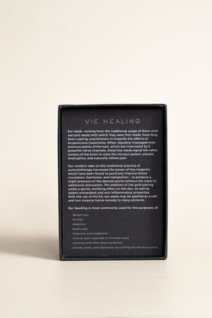 Back view of product packaging for Pain Conrol - 24K Gold Ear Seed | Vie Healing, featuring detailed text describing ear seed benefits and usage for wellness and pain relief.