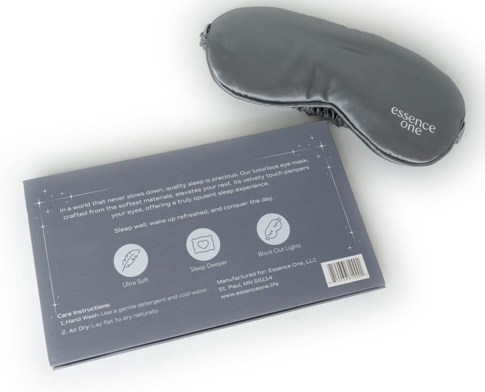 Luxury Sleep Eye Mask + Aromatherapy Set | Essence One featuring a smooth gray sleep mask and two small aromatherapy roll-ons in an elegant gift box with "sweet dreams" message inside.