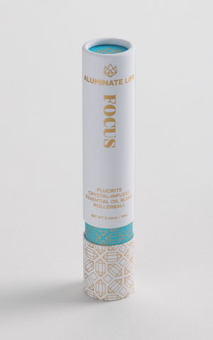 Focus Rollerball | Aluminate Life fluorite crystal-infused essential oil blend in a sleek white and gold container with decorative patterns for skincare and wellness use.