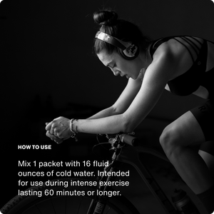 Black and white image of a focused woman wearing headphones and cycling, alongside instructions for Fuel 10-Travel Packs to mix one packet with 16 ounces of cold water for use during intense exercise lasting 60 minutes or longer.