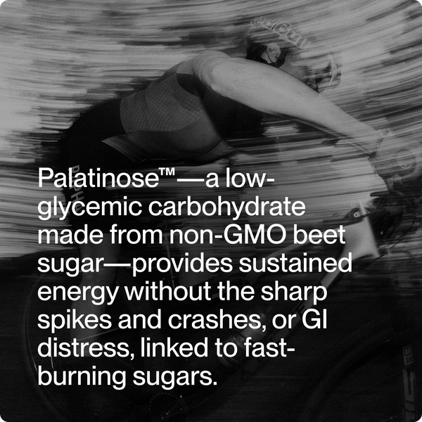 Black and white image of a cyclist in motion with overlay text describing Palatinose as a low-glycemic carbohydrate from non-GMO beet sugar providing sustained energy, included with Fuel 10-Travel Packs.