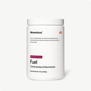 White container of Fuel drink mix labeled carbohydrates and electrolytes in cherry berry flavor for sustained energy and hydration during training.