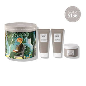 Kit Secret Garden | [ comfort zone ] skincare set displayed with artistic packaging featuring a seated woman in a garden and three taupe-colored body care tubes and jar.