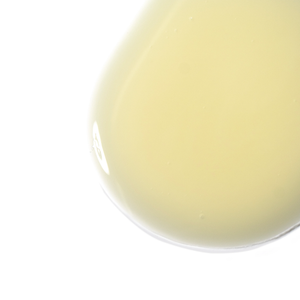 Close-up of a smooth, pale yellow serum droplet showcasing the texture of Hyaluronic Serum Sealer | Skin Fitness Therapy for skincare use.