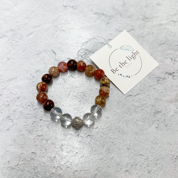 Agate Luxe Bracelet | Be the Light featuring polished multicolored agate beads combined with clear round beads and a decorative metallic accent, styled on a light surface with a branded tag.