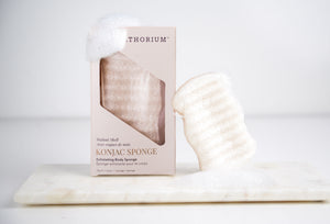 Konjac Walnut Exfoliating Body Sponge | Bathorium package and textured exfoliating sponge displayed on a white surface for gentle body care