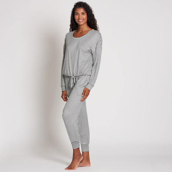 Woman wearing a striped comfortable lounge outfit standing barefoot against a plain background, showcasing the Jogger Sleep Set - 2PC | Lemon.