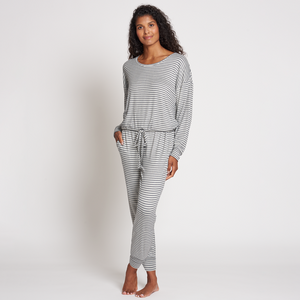 Woman wearing a comfortable gray and white striped long-sleeve top and jogger pants in a relaxed fit, styled for the Jogger Sleep Set - 2PC | Lemon collection.