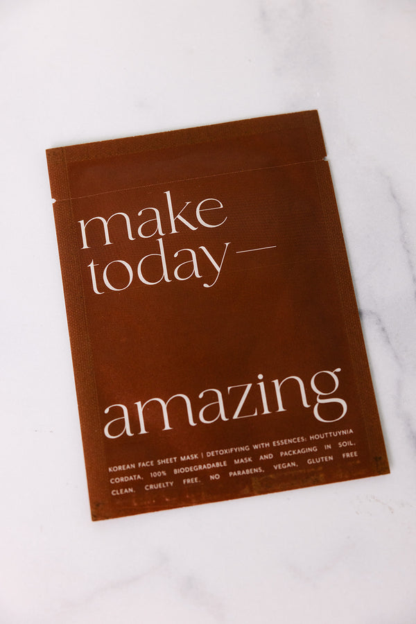 Brown packet of Korean Sheet Mask - Make Today Amazing | Lucky Owl with white minimalist typography on a white marble surface, highlighting skincare and eco-friendly features.