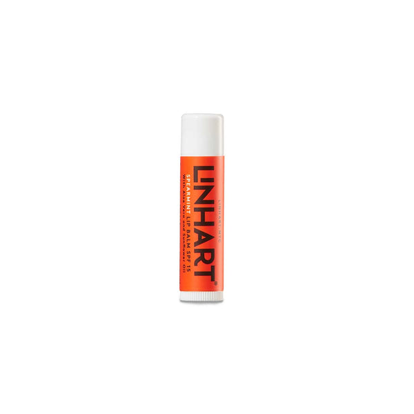 Lip Balm SPF 15 | LINHART in a bright orange tube designed for moisturizing and protecting lips with a spearmint scent, ideal for skincare and wellness.