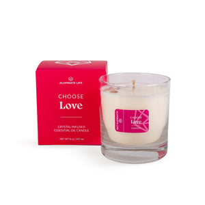 I Choose Love Candle | Aluminate Life features a crystal-infused essential oil blend in a clear glass container, paired with a vibrant red box for a soothing wellness experience.
