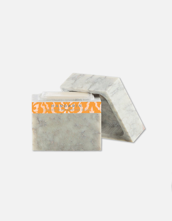 Two rectangular mandarin-scented soap bars with a marbled texture, one standing upright and one lying flat, featuring the label Concreta | Zents.