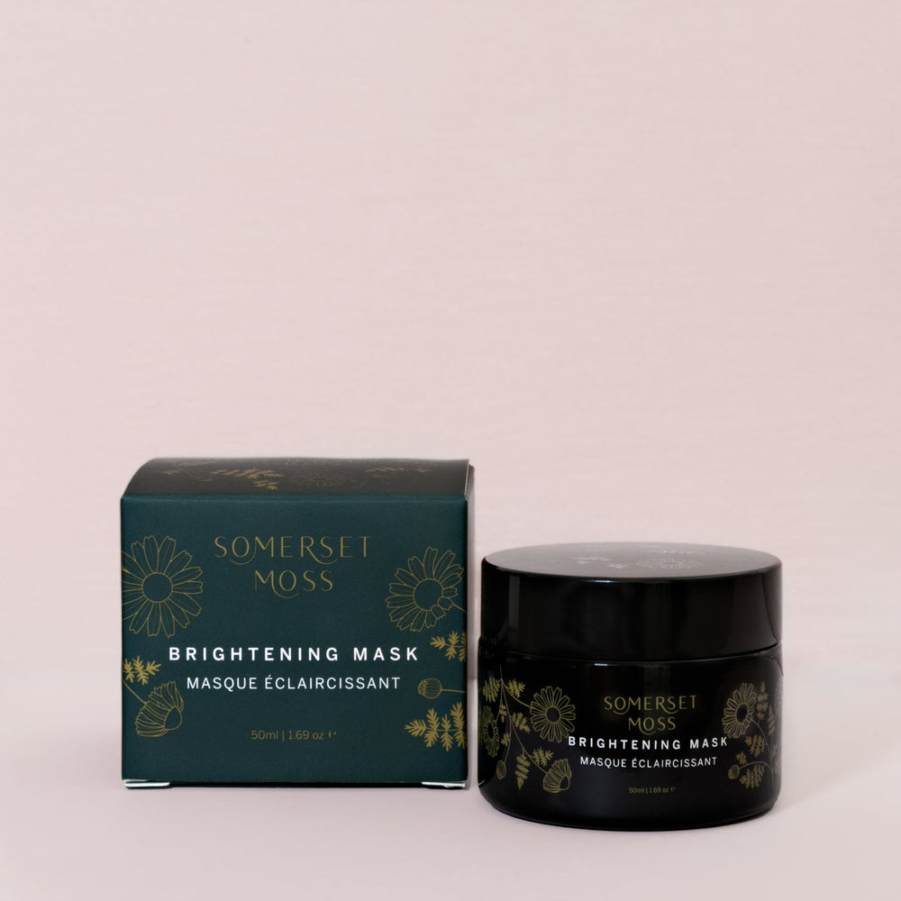 Black jar of Brightening Mask | Somerset Moss with gold floral design, promoting skincare and wellness in an elegant container.