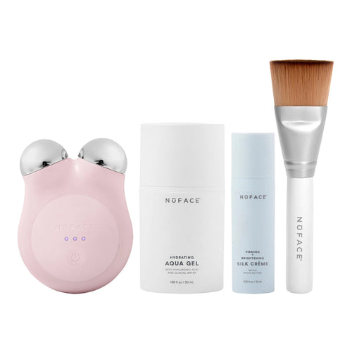 MINI+ Starter Kit | NuFACE featuring a pink facial toning device, hydrating aqua gel, firming silk crème, and a soft-bristle makeup brush for skincare and wellness routines.