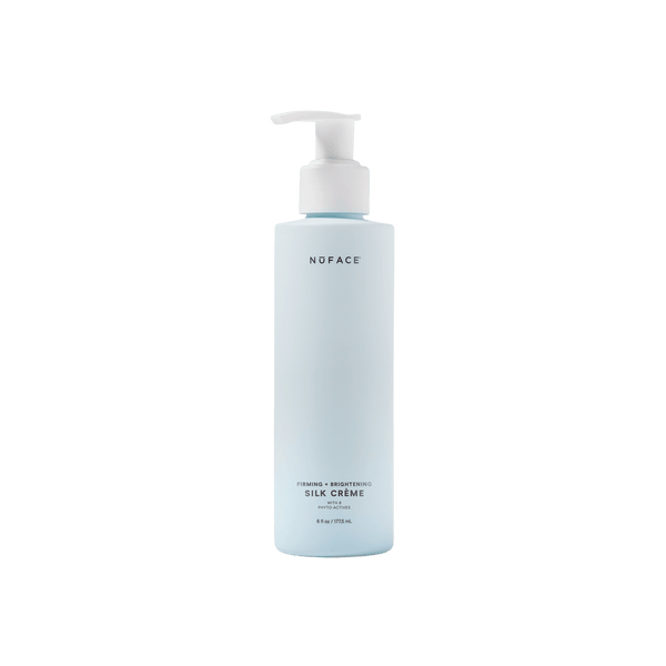 Bottle of Firming + Brightening Silk Crème | NuFACE, a skincare product in a light blue pump dispenser designed for firming and brightening the skin.