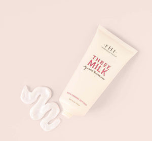 Tube of Three Milk moisturizer with creamy white lotion swirled beside it, part of the Silky, Milky & Most Loved Naked Nourishment Set | Farmhouse Fresh skincare collection.
