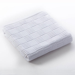 Folded white towel with a subtle textured geometric pattern, made from soft fabric for skincare and body care, part of the Hotel Collection Organic Cotton | TOWL.