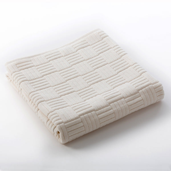 Folded natural beige textured towel with a subtle checkerboard pattern, highlighting softness and quality of the Hotel Collection Organic Cotton | TOWL.