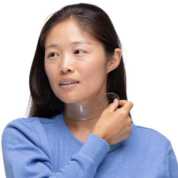 Woman with smooth skin applying a transparent neck wrinkle removal patch, highlighting skincare and body care in the Ageless Beauty Bundle | Dermaclara.