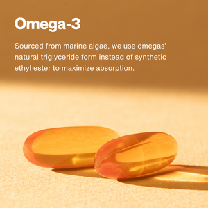 Close-up of two translucent omega-3 capsules on a warm beige surface with text explaining they are sourced from marine algae using natural triglyceride form for better absorption, part of The Momentous Three.