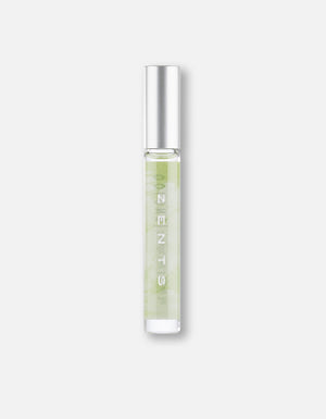 Clear glass roll-on bottle with light green liquid and silver cap, labeled "Attar Roll-on Scent | Zents," designed for personal fragrance and body care use.