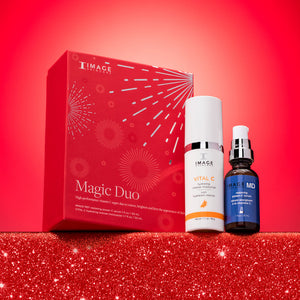 Red boxed set with white and blue skincare bottles displayed on glittery red surface against bright red background featuring Magic Duo | IMAGE Skincare products for skincare and wellness.