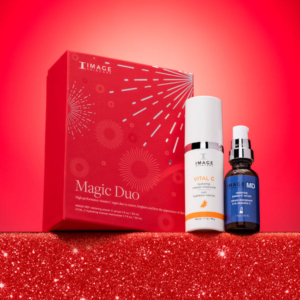 Red boxed set with white and blue skincare bottles displayed on glittery red surface against bright red background featuring Magic Duo | IMAGE Skincare products for skincare and wellness.
