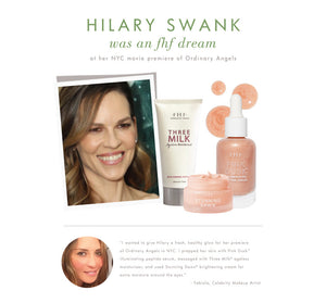 Promotional image featuring Hilary Swank smiling alongside skincare products from the Silky, Milky & Most Loved Naked Nourishment Set | Farmhouse Fresh, highlighting wellness and body care.