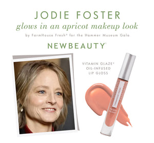 Jodie Foster with an apricot makeup look featuring Farmhouse Fresh Vitamin Glaze® Oil Infused Lip Gloss – Peach Peony displayed with a swatch.