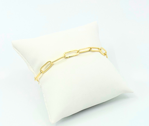 The Paperclip Bracelet (Gold) | Love You More displayed on a white cushion, featuring sleek and modern chain links in polished gold tone.