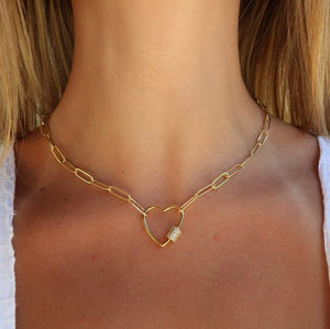 Close-up of a woman's neck wearing the Heart Link Gold Paperclip Chain Necklace (18" / White Crystal Studded) | Love You More, featuring a gold paperclip chain with a heart-shaped pendant studded with white crystals.
