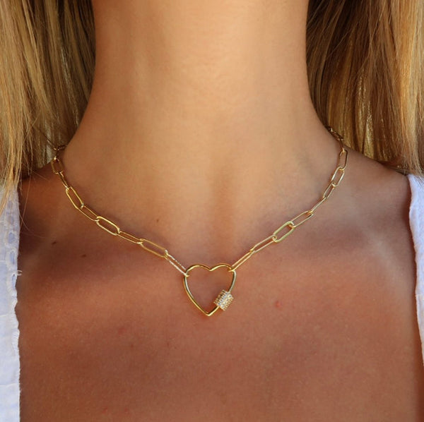 Close-up of a woman's neck wearing the Heart Link Gold Paperclip Chain Necklace (18" / White Crystal Studded) | Love You More, featuring a gold paperclip chain with a heart-shaped pendant studded with white crystals.
