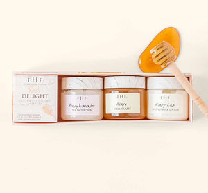 Set of three skincare jars including sea salt scrub, heel glaze, and milk lotion alongside a honey dipper with honey for the Fast Foot Revival Pedi Delight Sampler | Farmhouse Fresh.