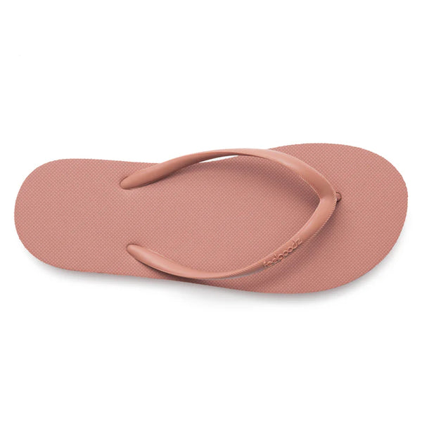 Top view of a single muted coral-colored flip flop sandal with a simple textured footbed and thin straps, Slimz Core Sandals | Feelgoodz.