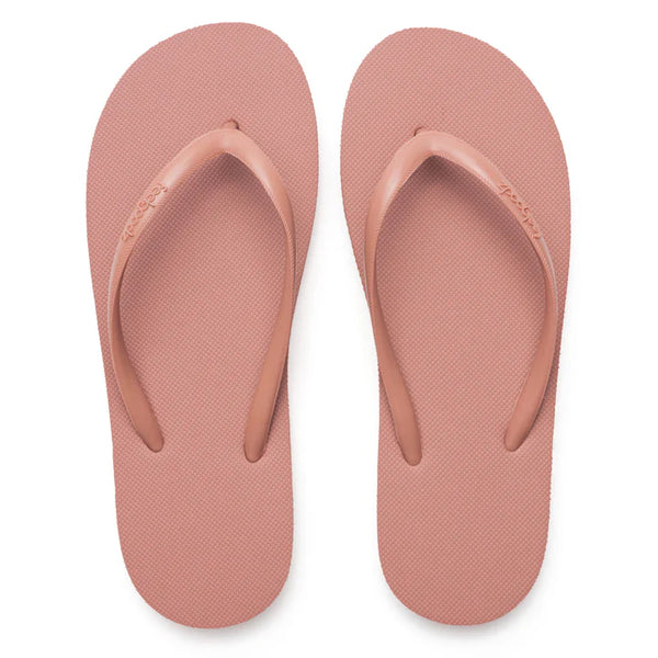 A pair of slim, minimalist pink sandals with textured soles and simple straps, designed for comfortable casual wear, labeled Slimz Core Sandals | Feelgoodz.