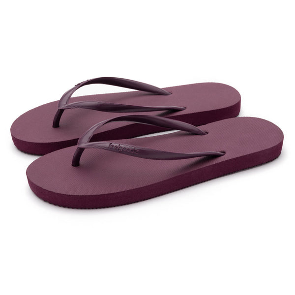 Pair of simple maroon flip-flop sandals with thin straps, designed for comfort and casual wear, featuring Slimz Core Sandals | Feelgoodz branding.